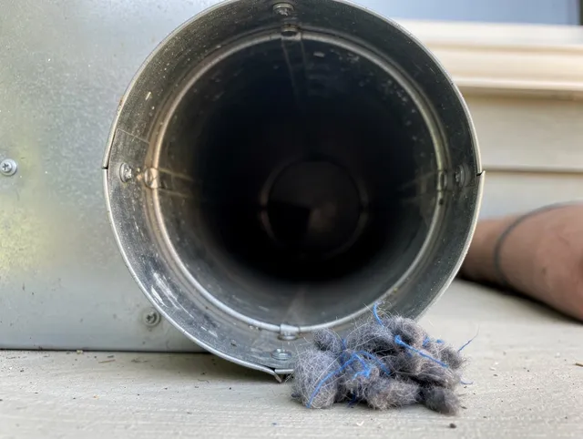 Brecksville Dryer Vent Cleaning technician using specialized equipment to clear severe dryer vent blockage in Brecksville
